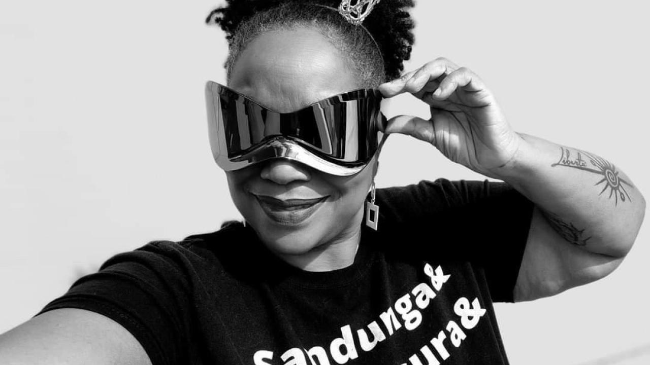 A black and white photo of a woman with elaborate sunglasses