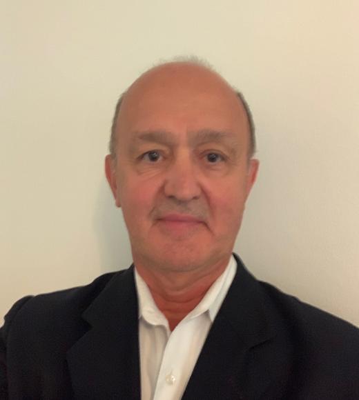 Man in a dark suit and white dress shirt