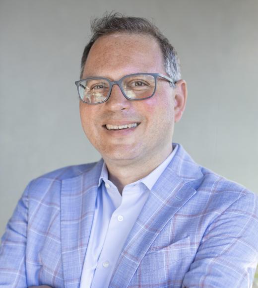 Man in glasses and a pale blue suit