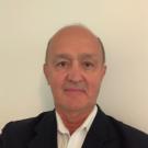 Man in a dark suit and white dress shirt