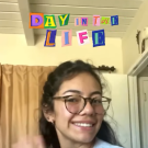 Girl in her bedroom waving