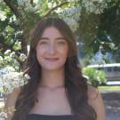 woman in front of white blooming tree